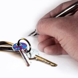 hand signing agreement and home keys